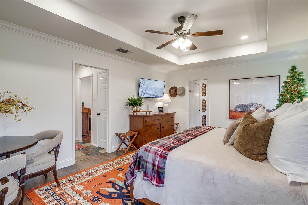 1930 Bethel Road Weatherford, TX 76086 - Photo 16 of 33 a bedroom with a bed with furniture and a chandelier