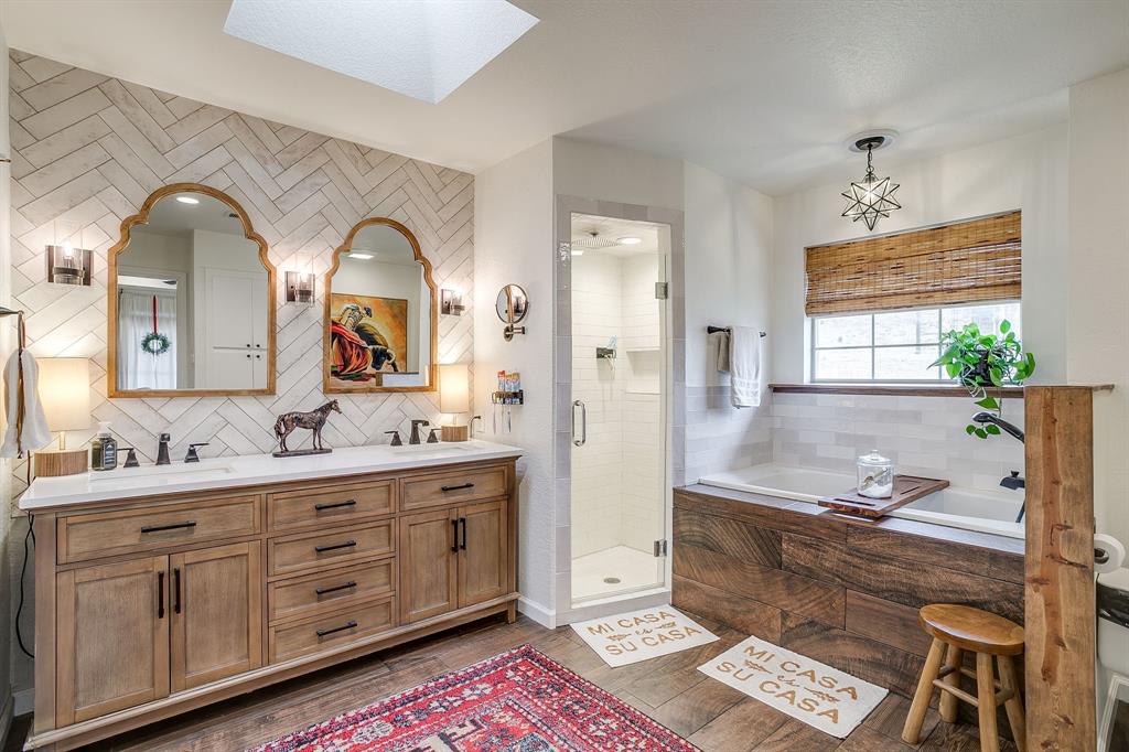 1930 Bethel Road Weatherford, TX 76086 - Photo 17 of 33 a spacious bathroom with a double vanity sink a mirror and a bathtub