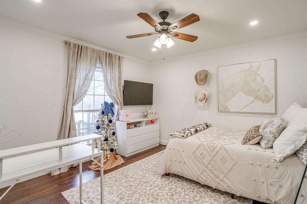 1930 Bethel Road Weatherford, TX 76086 - Photo 23 of 33 a bedroom with a bed and a flat screen tv