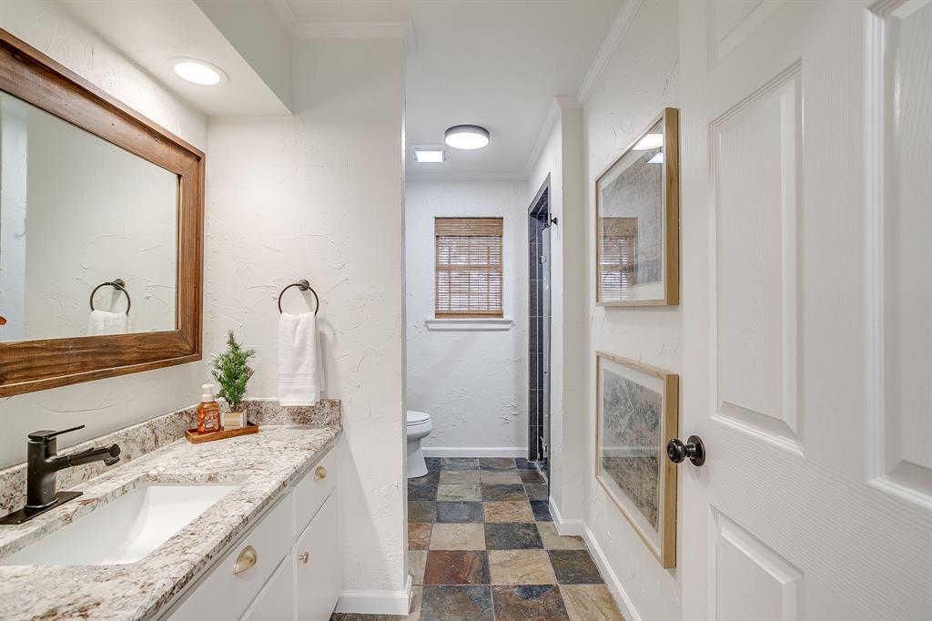 1930 Bethel Road Weatherford, TX 76086 - Photo 26 of 33 a bathroom with a granite countertop sink and a mirror
