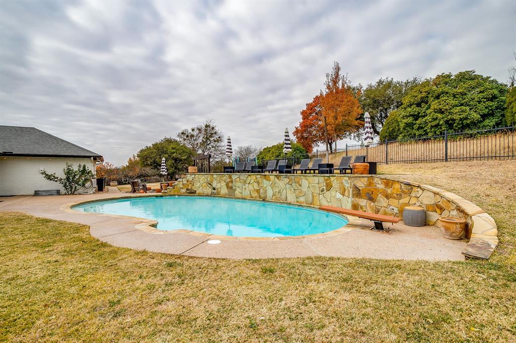 1930 Bethel Road Weatherford, TX 76086 - Photo 31 of 33 a view of a swimming pool with an outdoor seating and a yard