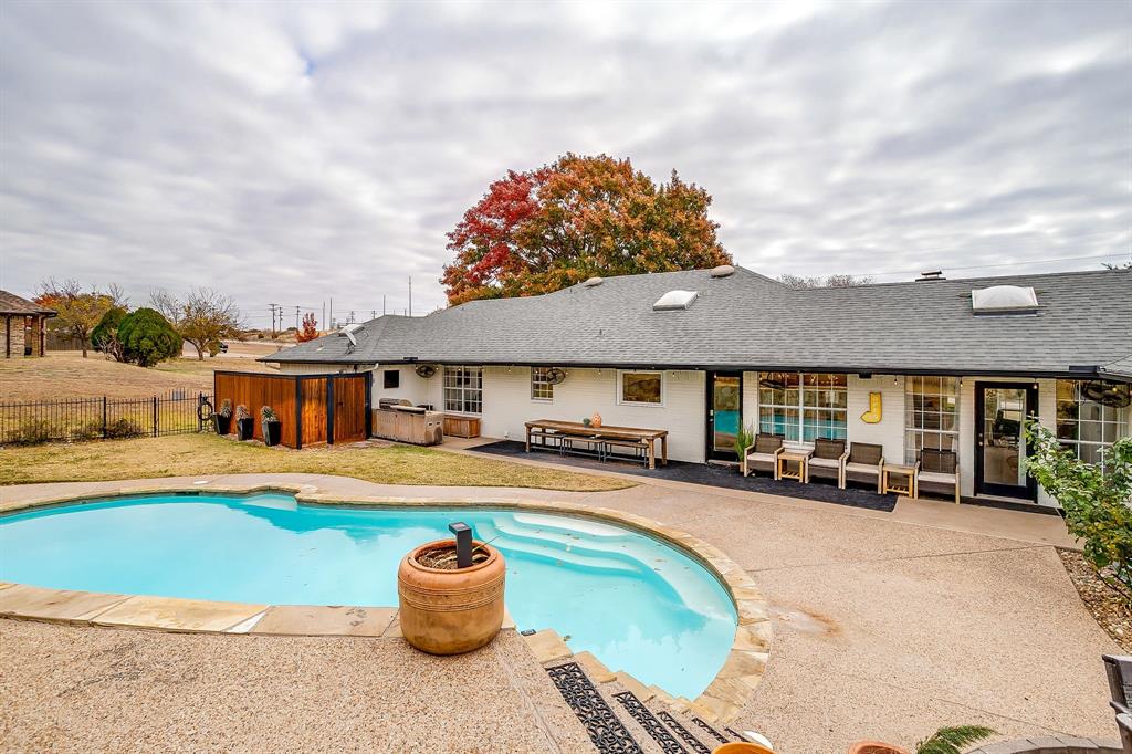 1930 Bethel Road Weatherford, TX 76086 - Photo 32 of 33 a front view of a house with a swimming pool and a fire pit
