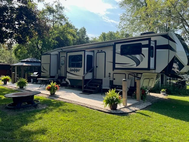 a view of a house with backyard furniture and a patio