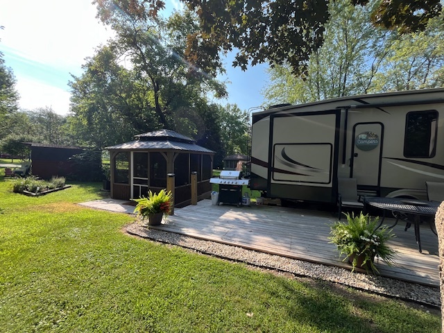 2795 East 28th Road Marseilles, IL 61341 - Photo 25 of 68 a view of backyard with a table and chairs under an umbrella