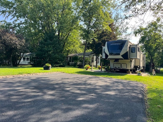 2795 East 28th Road Marseilles, IL 61341 - Photo 3 of 68 a view of a swimming pool with lawn chairs and large trees