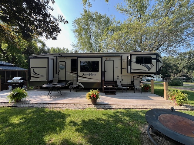 2795 East 28th Road Marseilles, IL 61341 - Photo 4 of 68 a view of a backyard with furniture and a flat screen tv