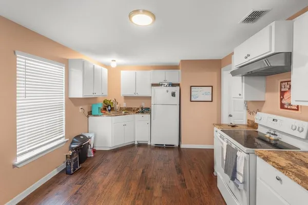 a kitchen with a stove and a microwave