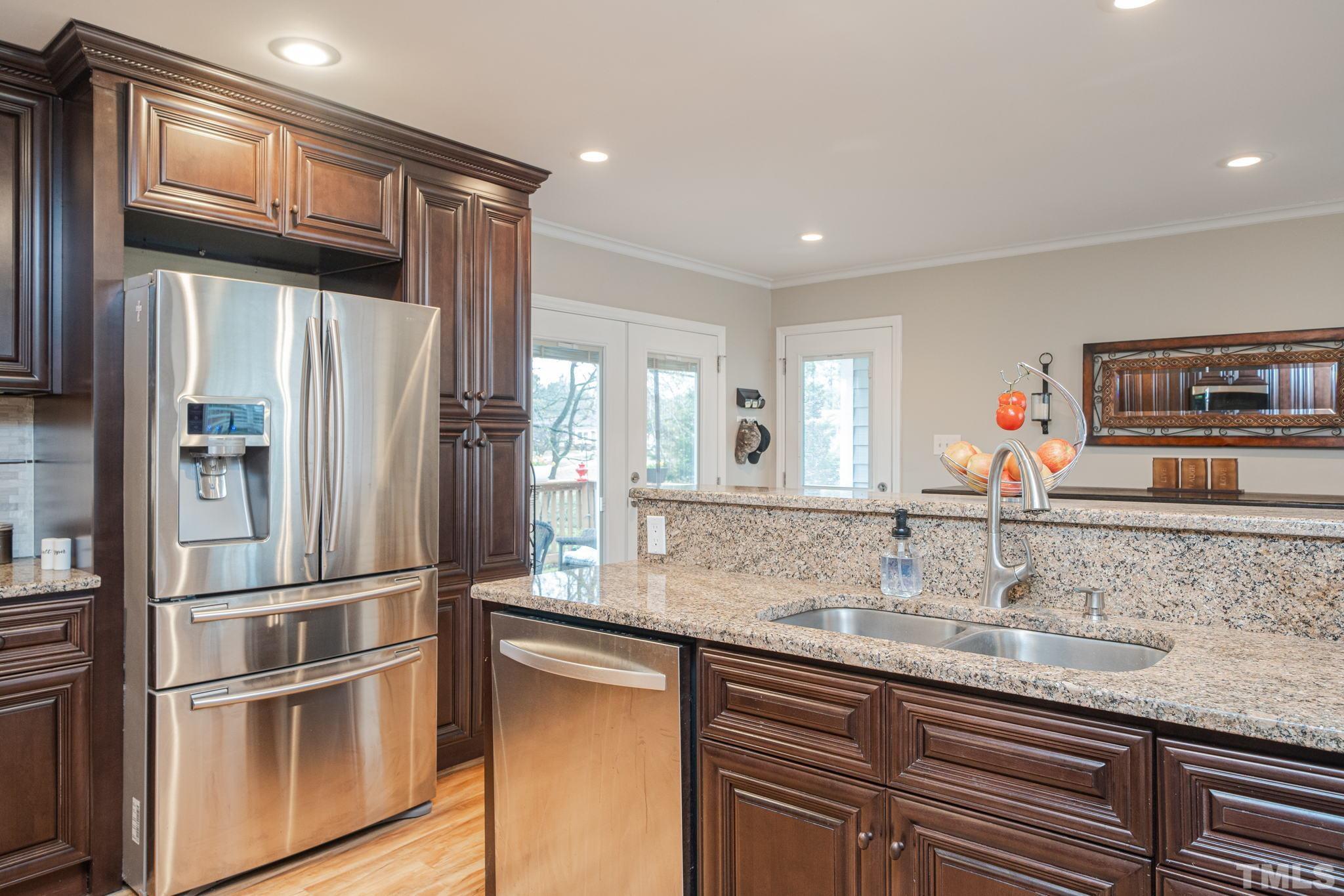 10104 Jordan Road Raleigh, NC 27603 - Photo 11 of 26 a kitchen with stainless steel appliances granite countertop a refrigerator and a sink