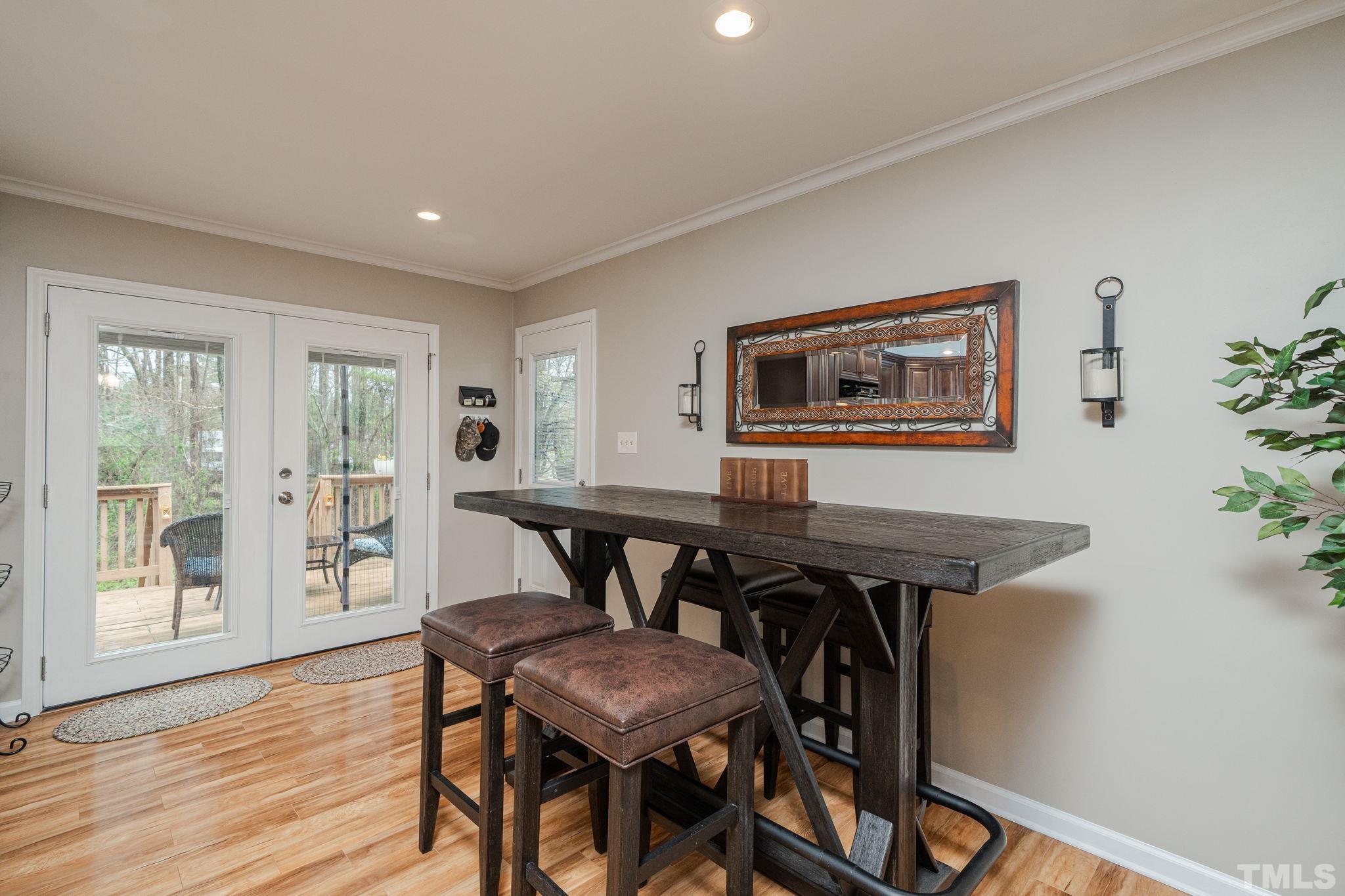 10104 Jordan Road Raleigh, NC 27603 - Photo 15 of 26 a view of a dining room with furniture and wooden floor