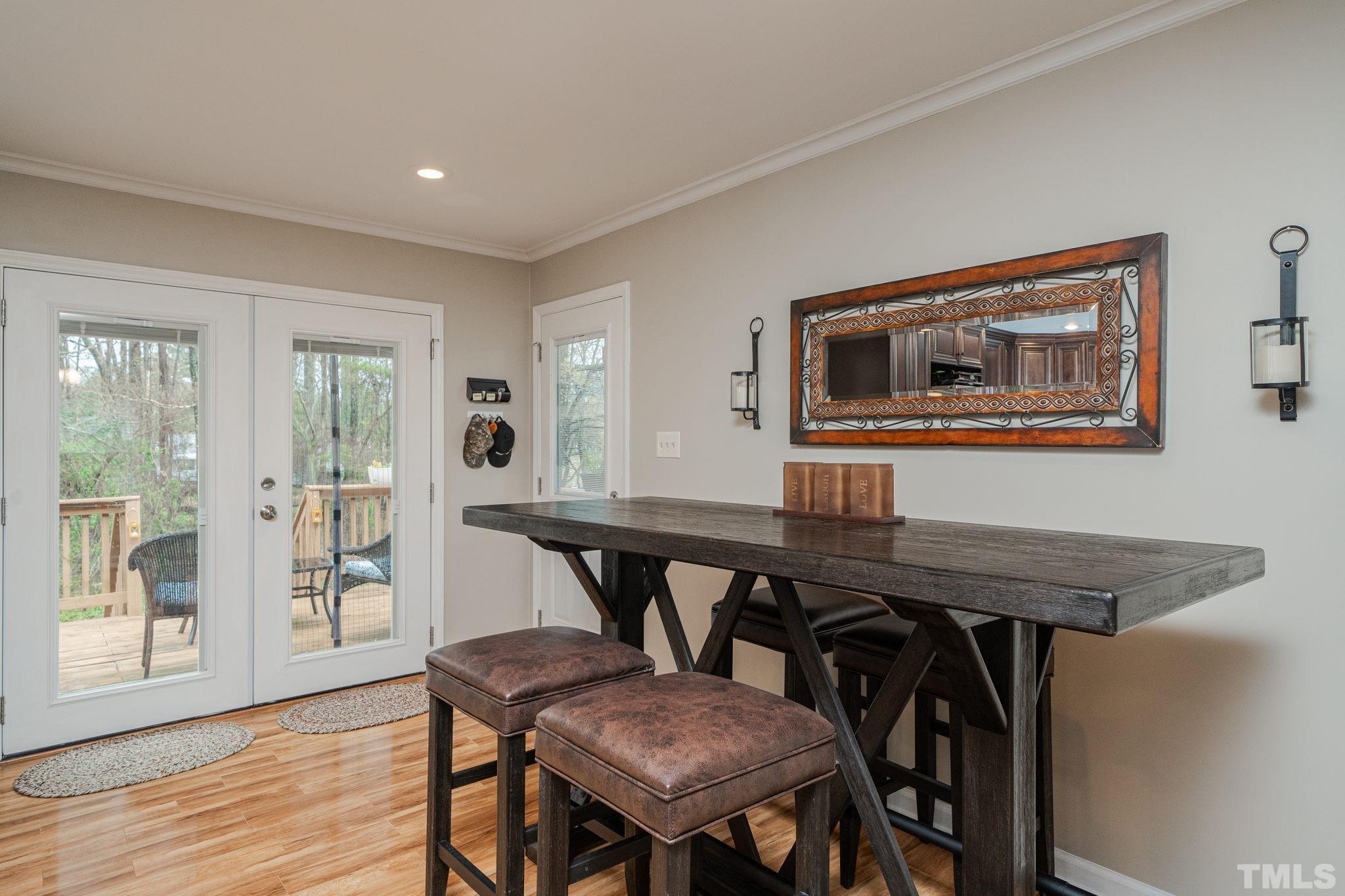 10104 Jordan Road Raleigh, NC 27603 - Photo 16 of 26 a view of a dining room with furniture and wooden floor