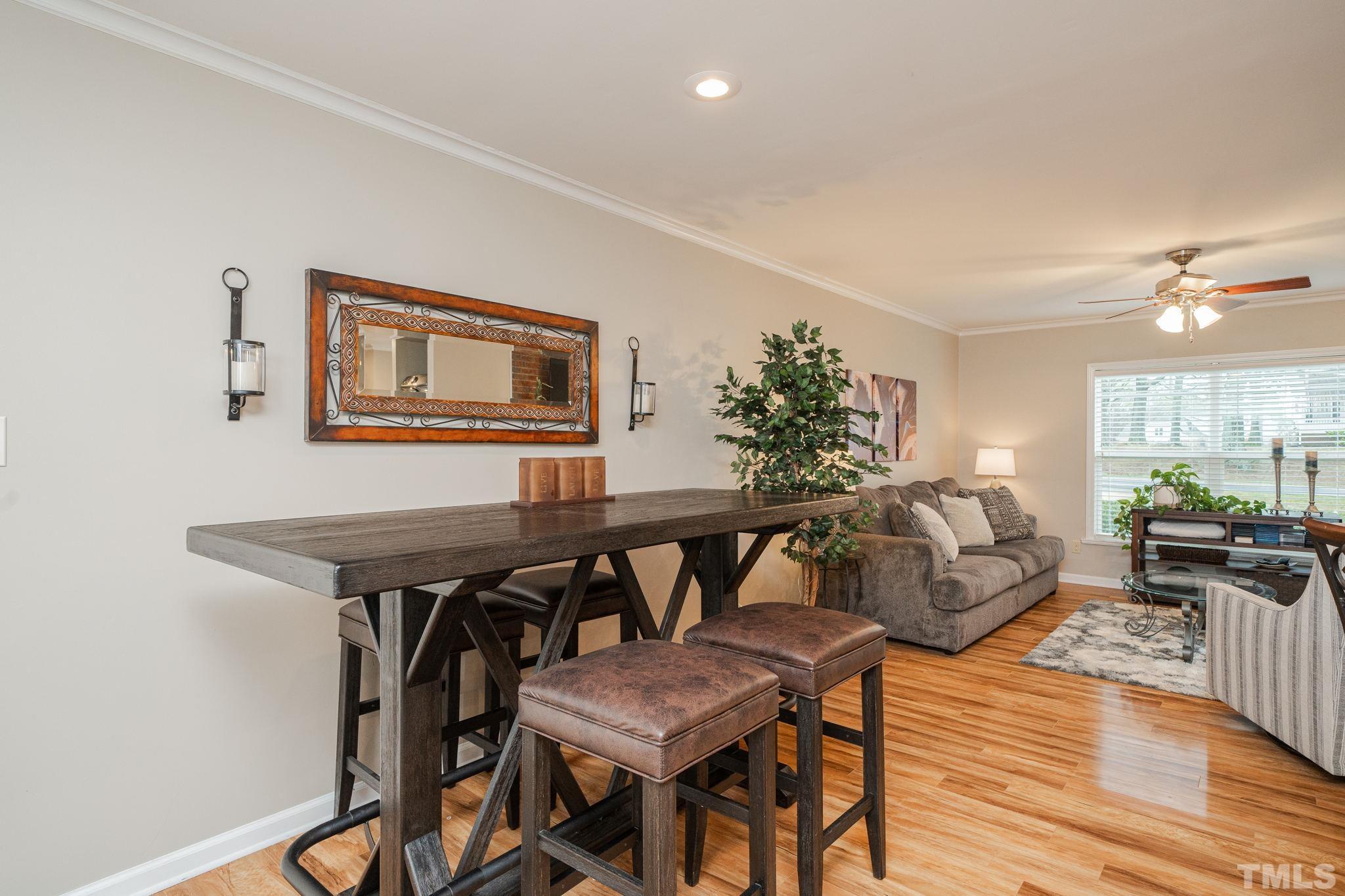 10104 Jordan Road Raleigh, NC 27603 - Photo 18 of 26 a view of a dining room with furniture and wooden floor