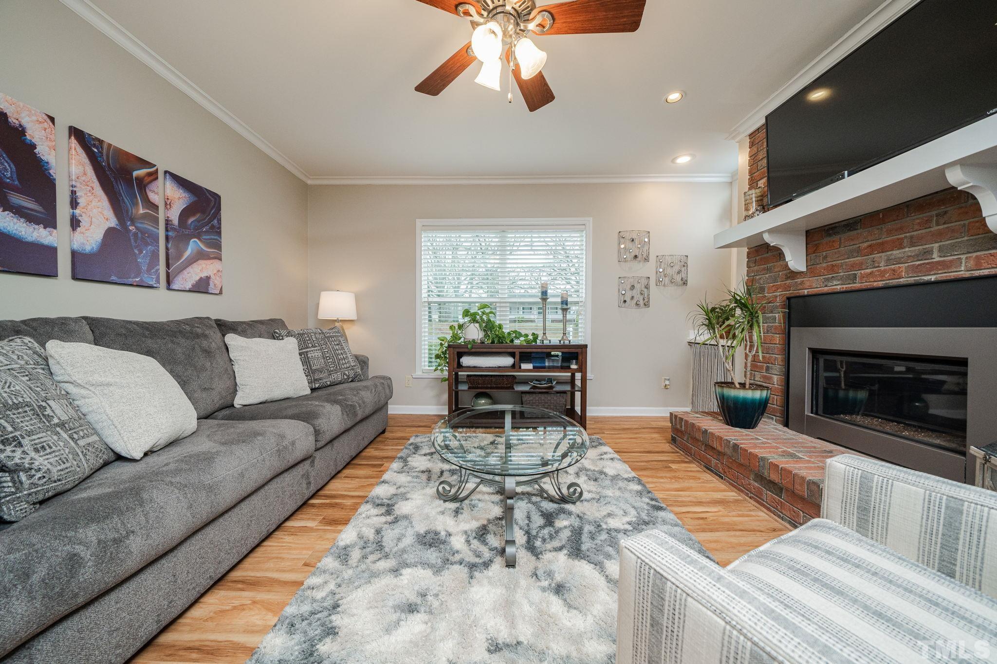 10104 Jordan Road Raleigh, NC 27603 - Photo 20 of 26 a living room with furniture and a fireplace