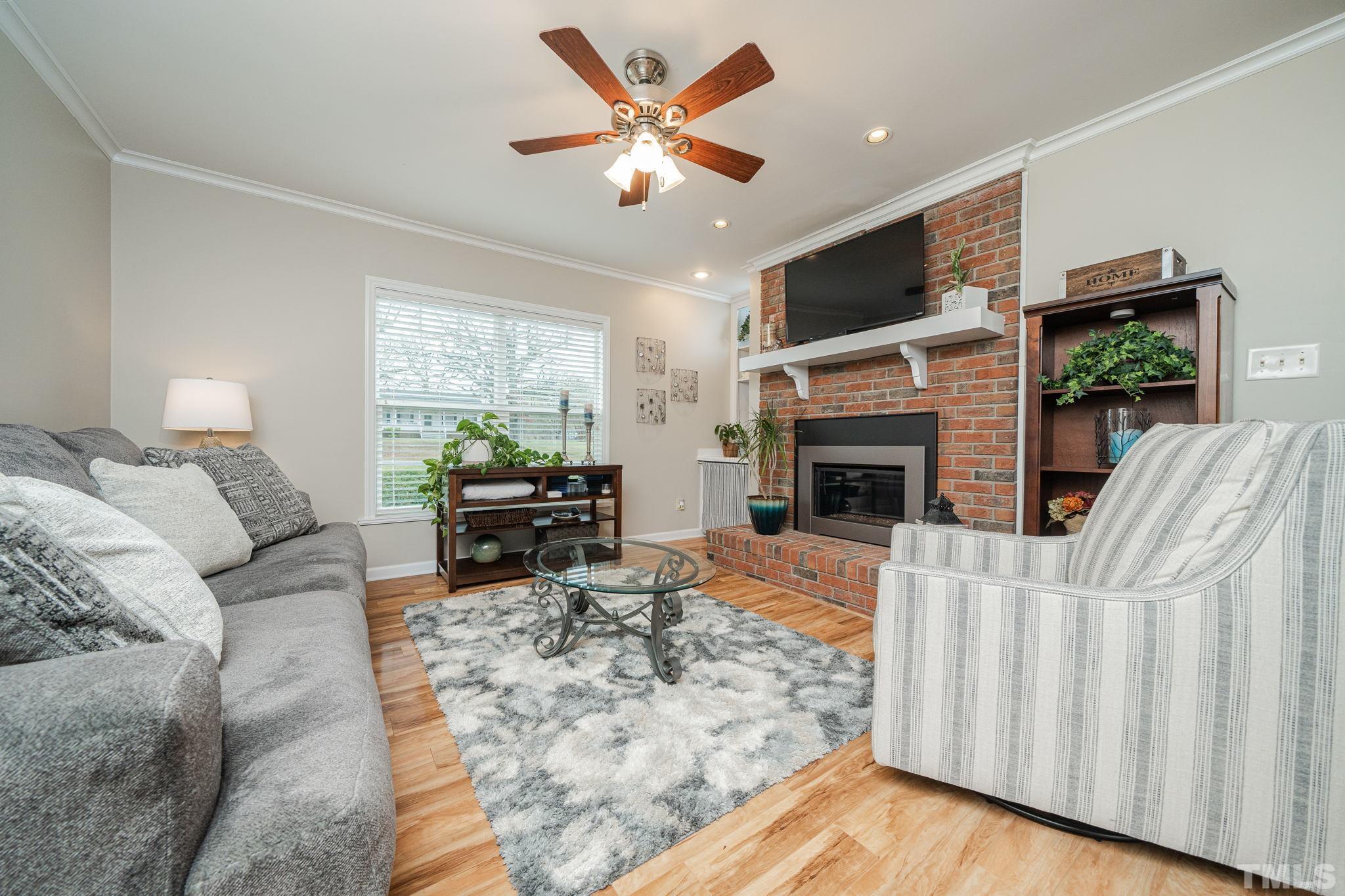 10104 Jordan Road Raleigh, NC 27603 - Photo 21 of 26 a living room with furniture fireplace and flat screen tv