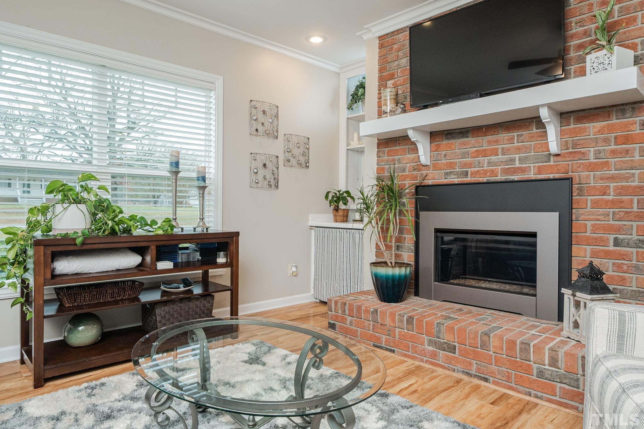 10104 Jordan Road Raleigh, NC 27603 - Photo 23 of 26 a living room with furniture and a fireplace