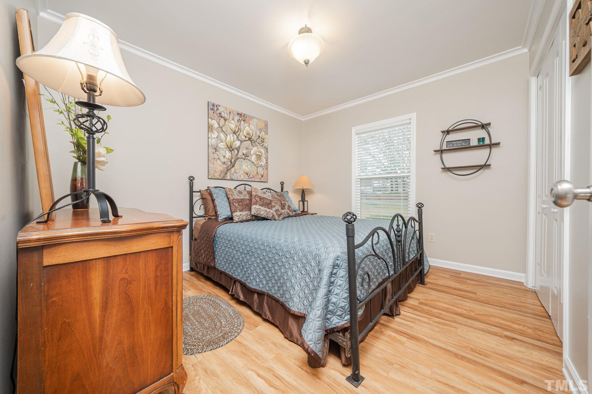 10104 Jordan Road Raleigh, NC 27603 - Photo 26 of 26 a bedroom with a bed and wooden floor