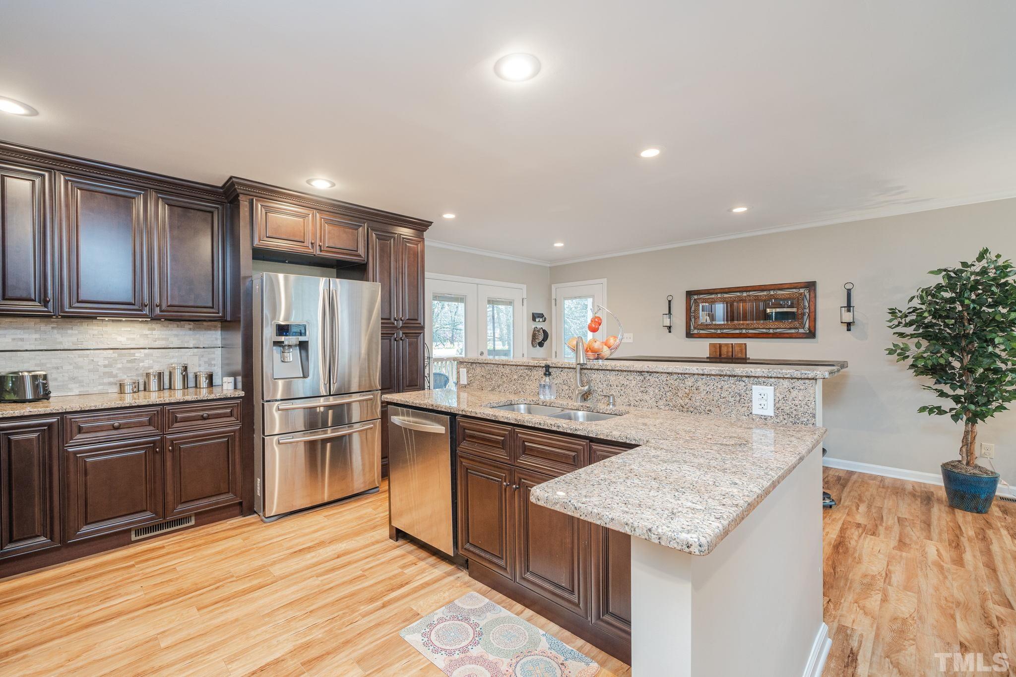 10104 Jordan Road Raleigh, NC 27603 - Photo 8 of 26 a kitchen with stainless steel appliances granite countertop a sink stove and refrigerator