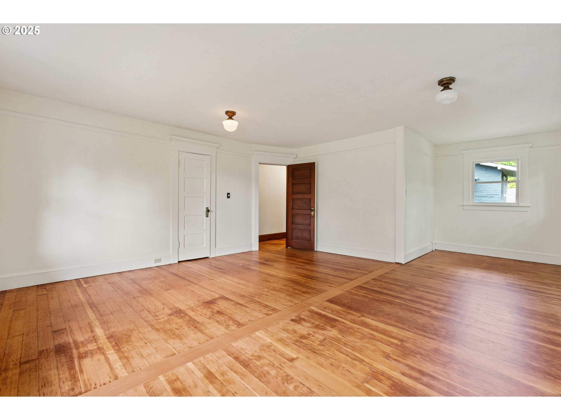 2404 Northeast 47th Avenue Portland, OR 97213 - Photo 22 of 35 a view of an empty room with wooden floor and a window