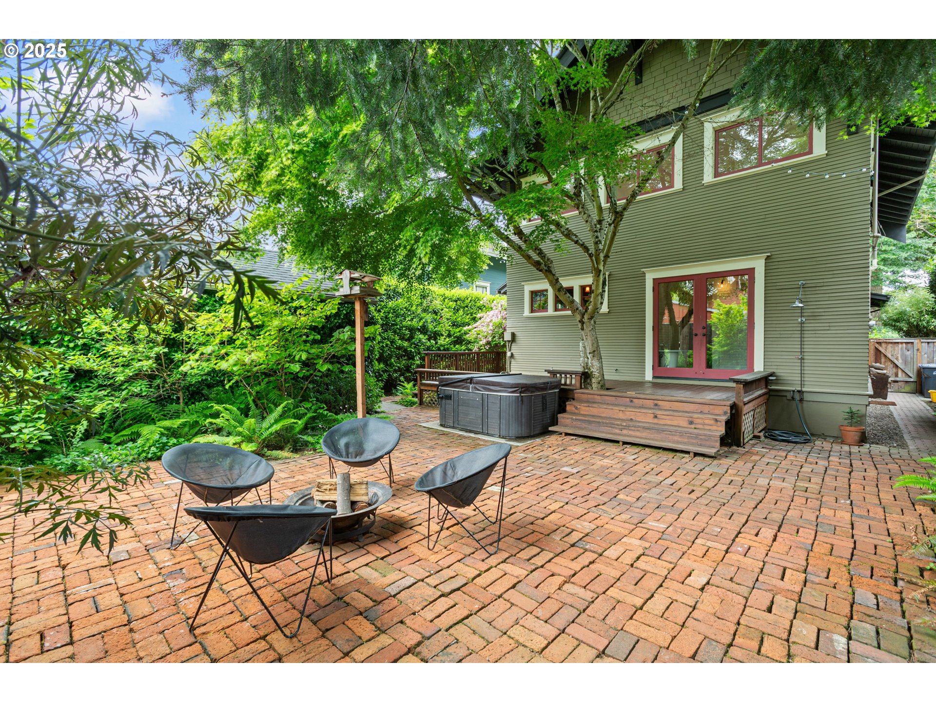 2404 Northeast 47th Avenue Portland, OR 97213 - Photo 28 of 35 a view of a patio with a dining table and chairs with a fire pit