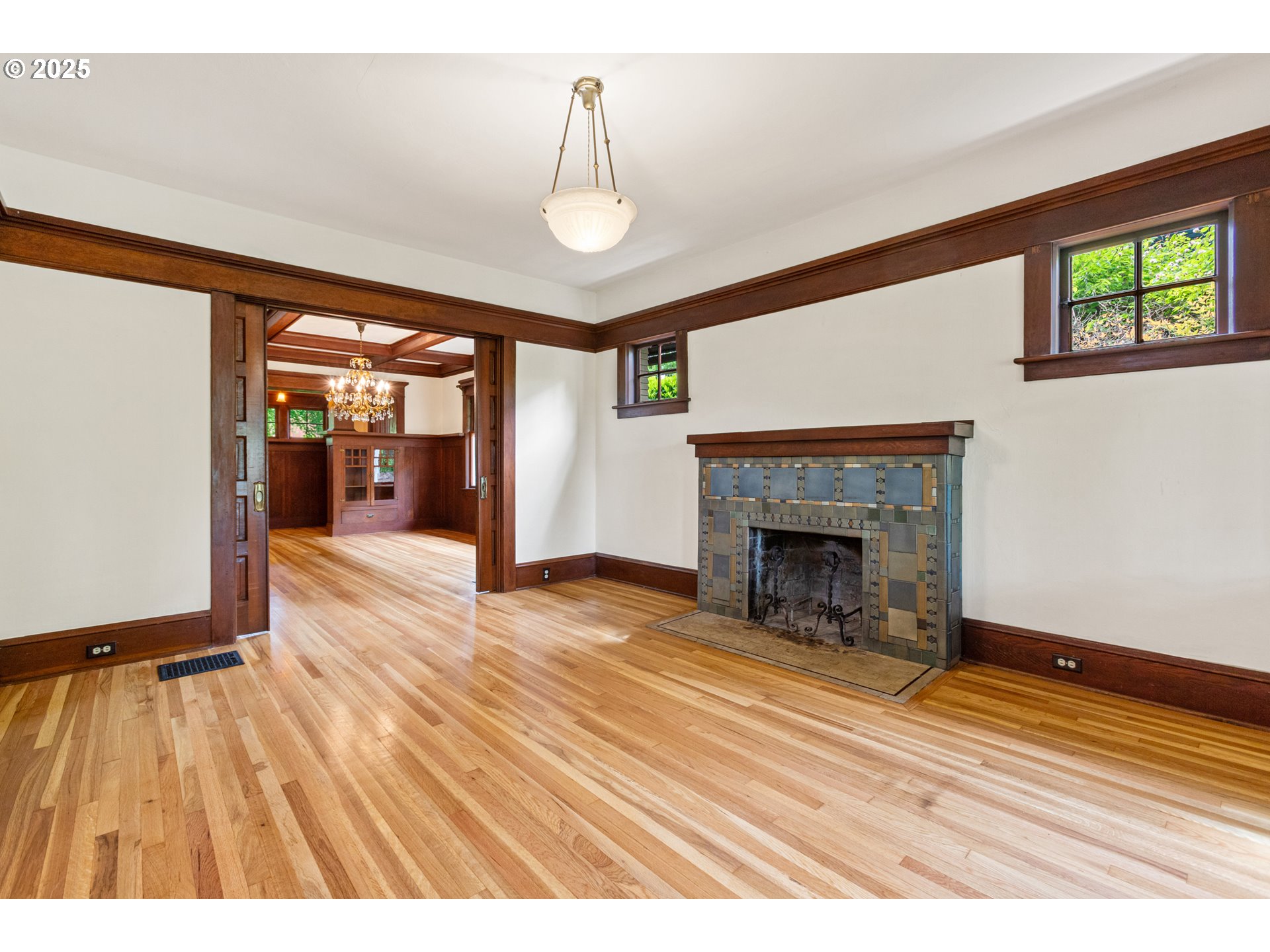 2404 Northeast 47th Avenue Portland, OR 97213 - Photo 8 of 35 a view of an empty room with wooden floor fireplace and a window