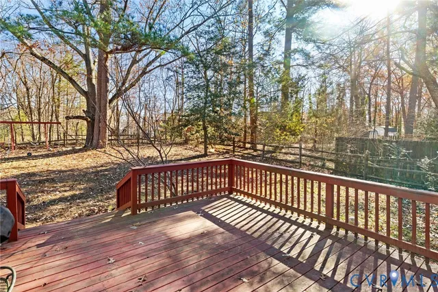 a view of a balcony with wooden floor and fence