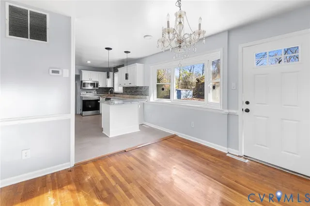 a view of a kitchen with a stove top oven