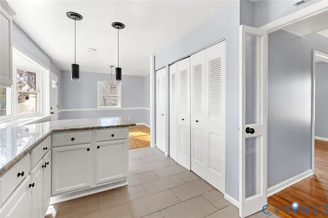 a spacious bathroom with a granite countertop sink a mirror a bathtub and shower