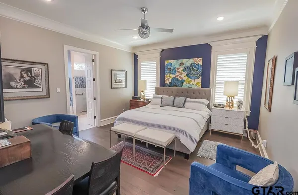 a bedroom with a bed and a desk
