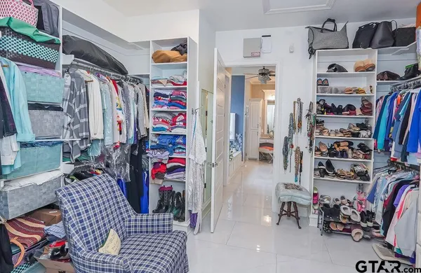 a view of walk in closet with clothes