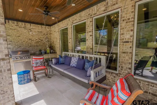 a outdoor living space with furniture and a fireplace