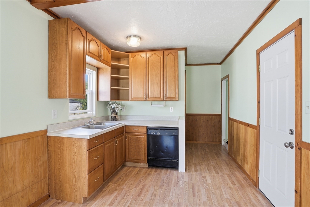 12 Whitcomb Street Webster, MA 01570 - Photo 10 of 40 a kitchen with stainless steel appliances granite countertop wooden floor sink stove and refrigerator