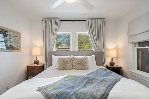 a bedroom with a bed and window