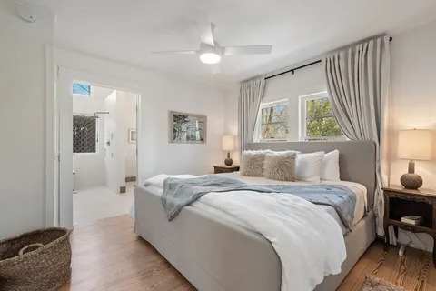 a spacious bedroom with a bed and a window