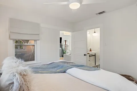 a bedroom with a bed and a mirror