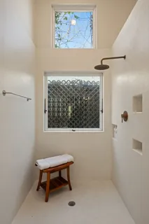 a bathroom with a toilet and a shower
