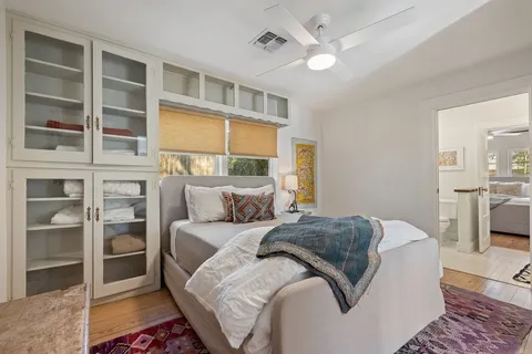 a living room with a bed furniture and a window
