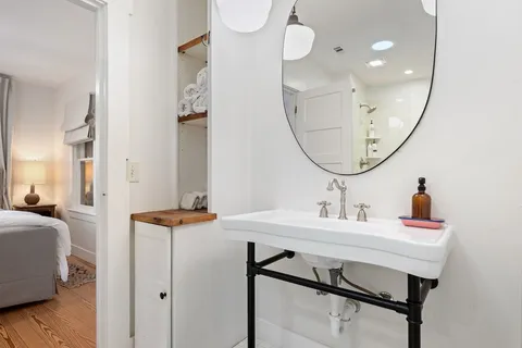 a bathroom with a sink a mirror and a vanity