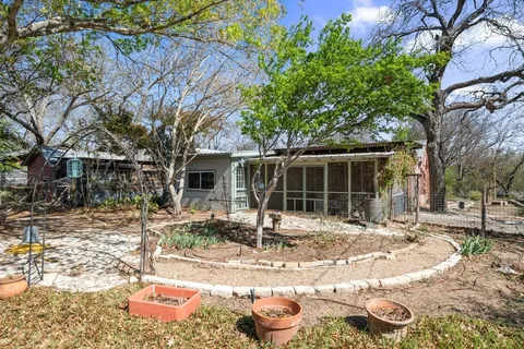 a backyard of a house with yard and outdoor seating