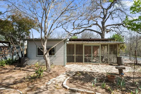 a house with a large tree in front of it