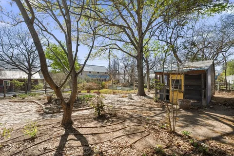a view of a house with a yard covered in snow