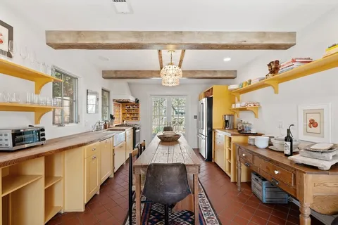 a large kitchen with a table and chairs in it