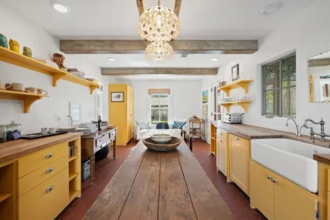 a large kitchen with kitchen island lots of counter space wooden floor and stainless steel appliances