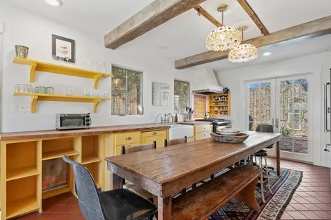 a view of a dining room with furniture a chandelier and wooden floor