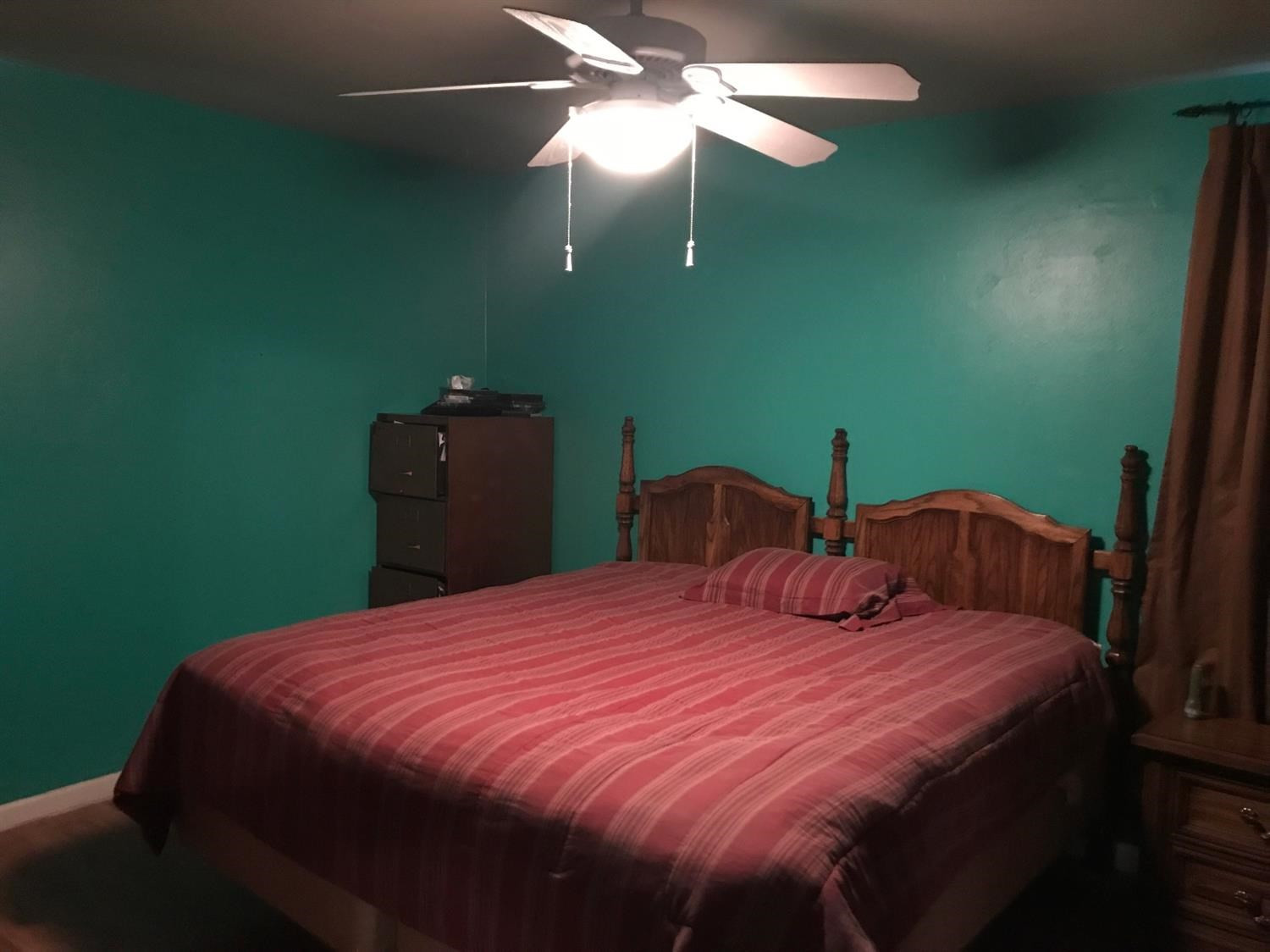 5509 43rd Street Lubbock, TX 79414 - Photo 5 of 10 a bedroom with a bed and a chandelier