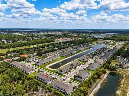 an aerial view of residential houses with yard