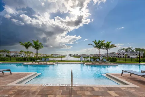 a view of a swimming pool with a lounge chairs