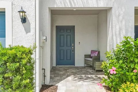 a view of a door and chair in back yard of a house