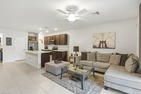 a living room with furniture and kitchen view