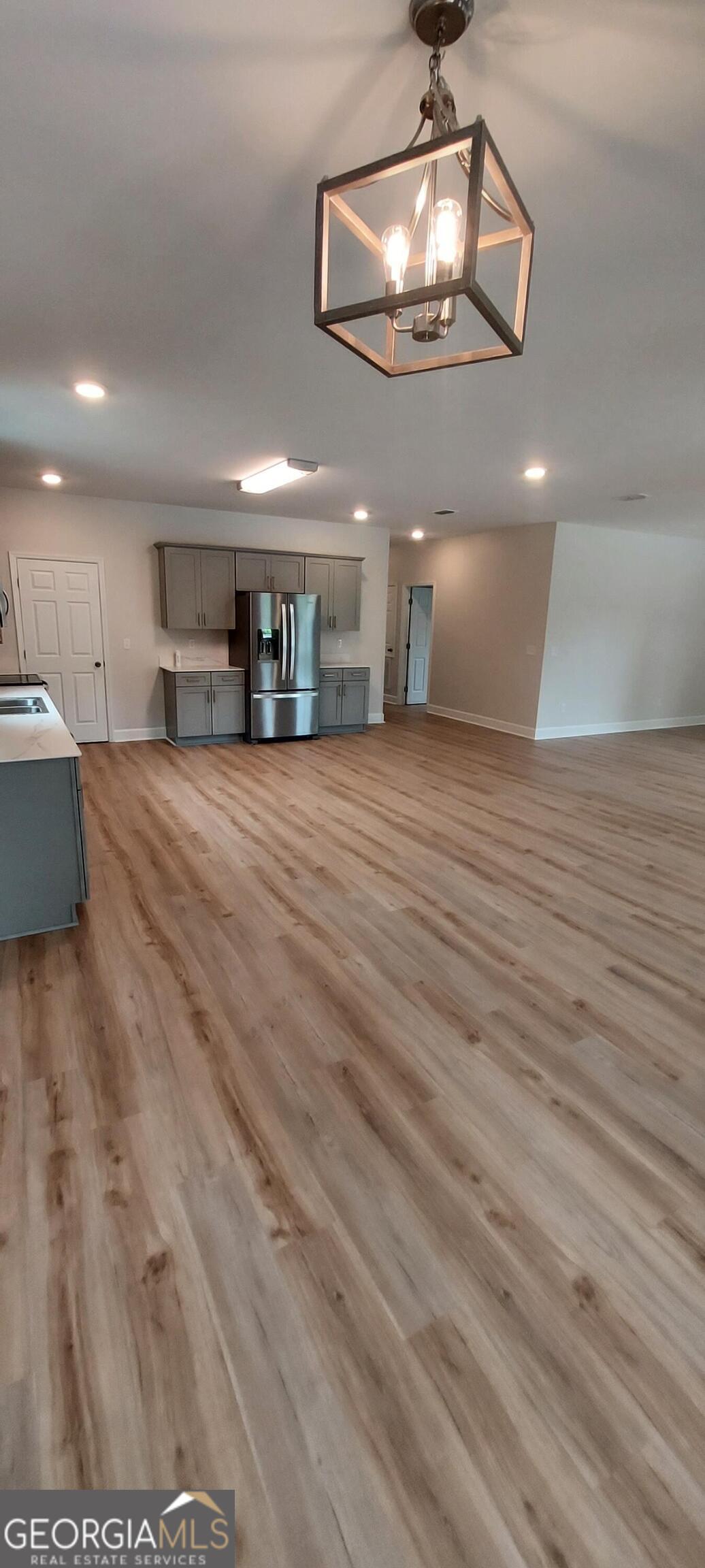 415 Charles Street Bainbridge, GA 39819 - Photo 2 of 9 a view of livingroom and kitchen with hardwood floor