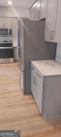 a kitchen with stainless steel appliances a refrigerator and a stove