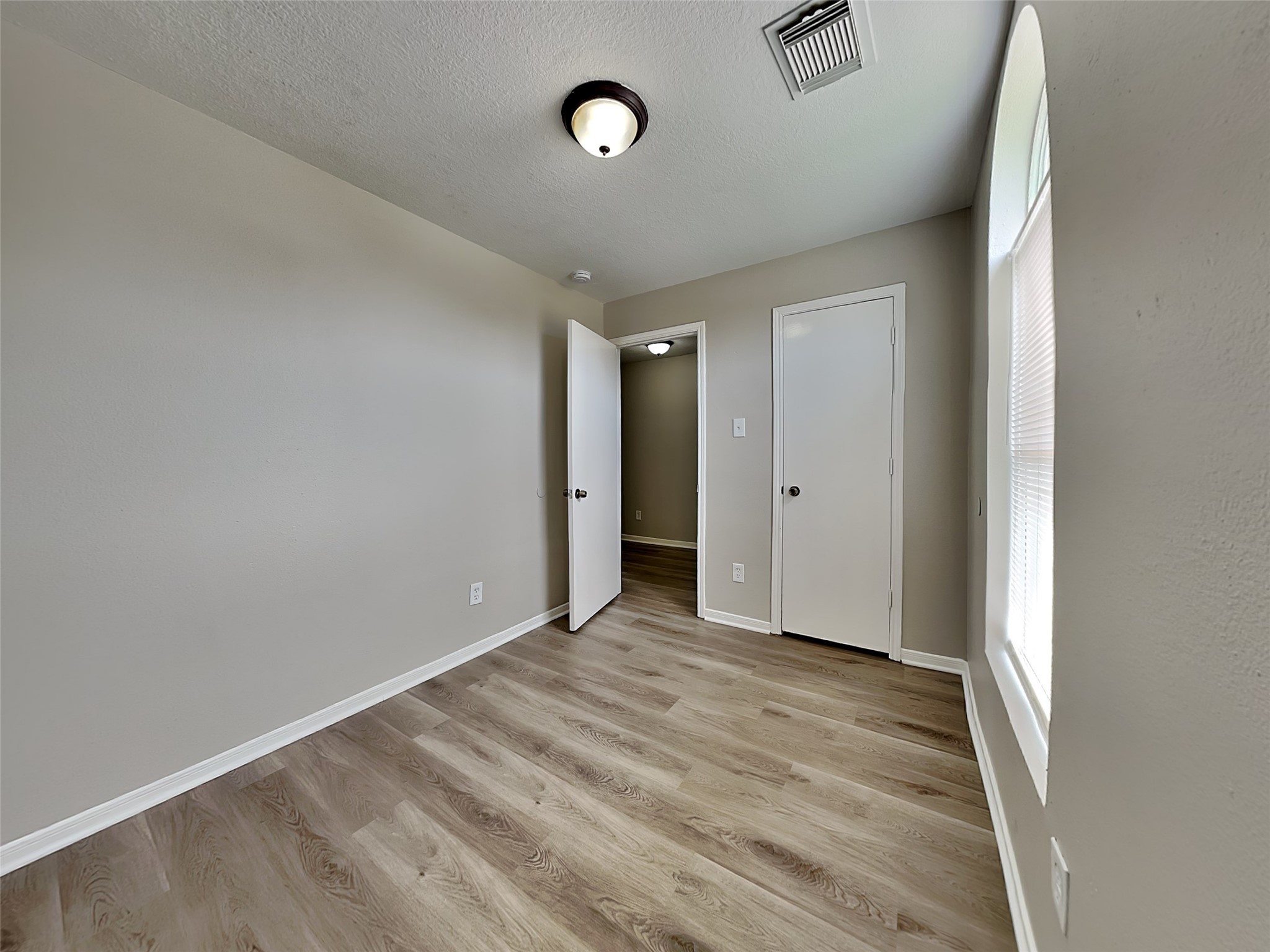 15019 Easingwold Drive Channelview, TX 77530 - Photo 11 of 17 a view of an empty room with wooden floor